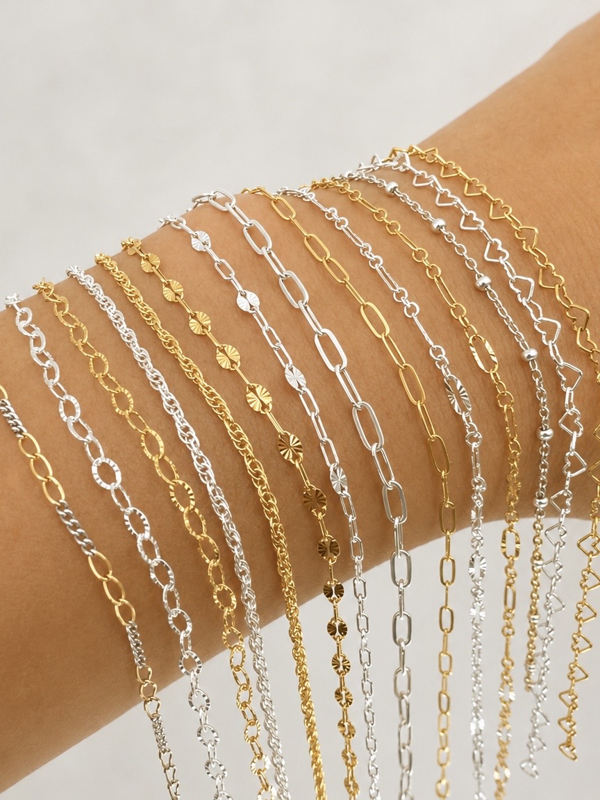 Gold and silver permanent jewelry chains displayed on an arm