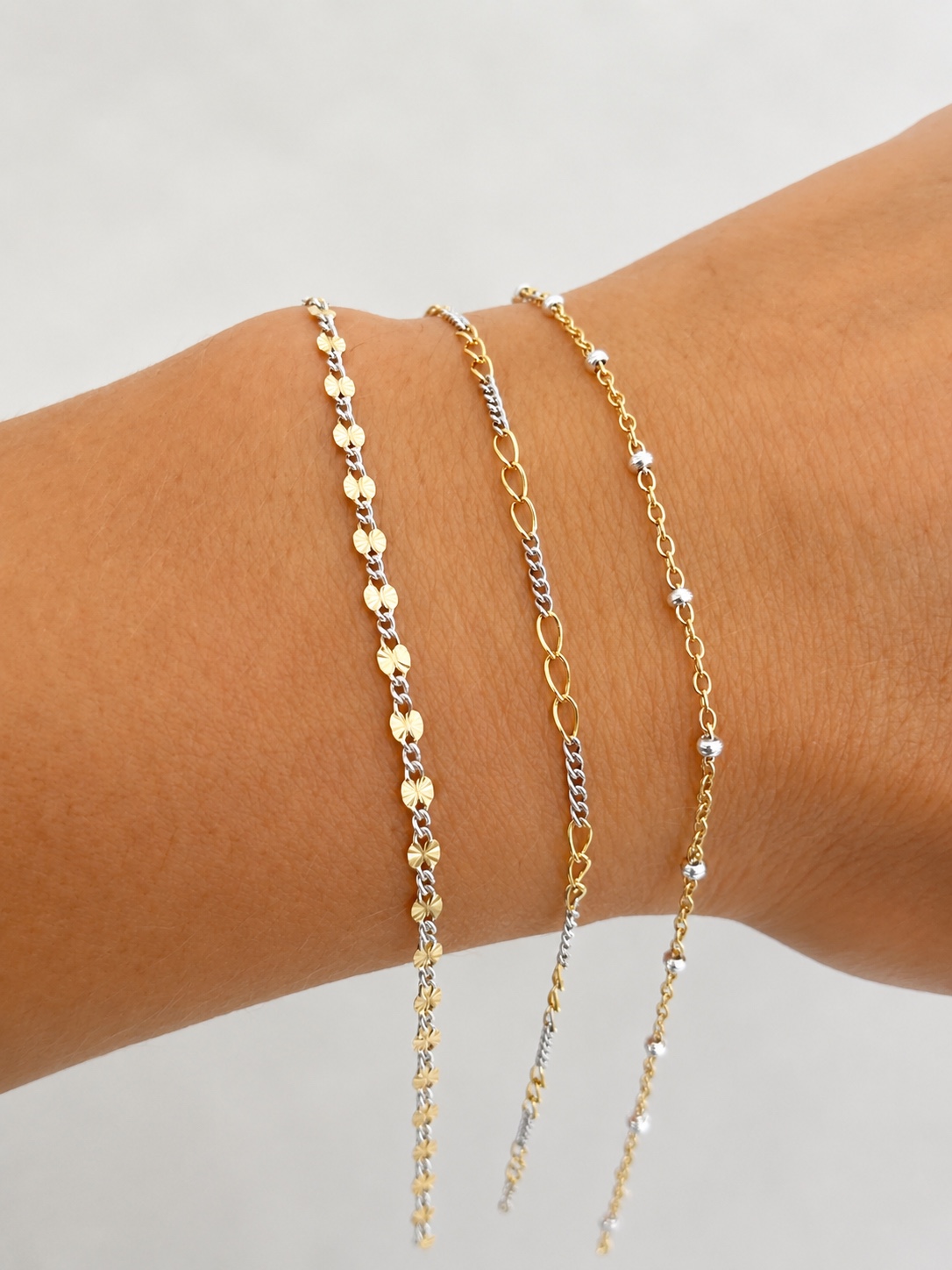 Three mixed-metal permanent jewelry chains
